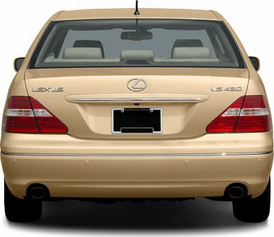 Rear view with taillights, chrome trim, and dual exhaust on luxury sedan