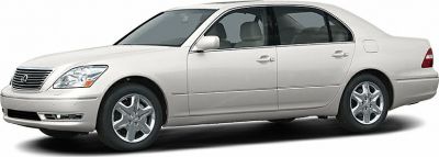 Side profile of a mid-2000s luxury four-door sedan with chrome wheels