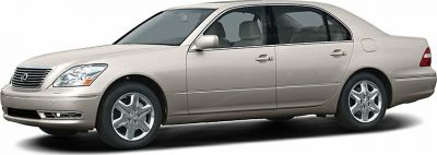Side profile of a beige sedan with chrome wheels