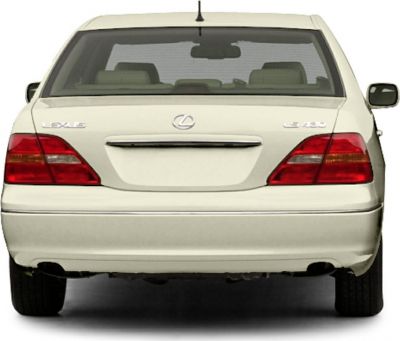 Rear view of white luxury sedan with taillights and badges