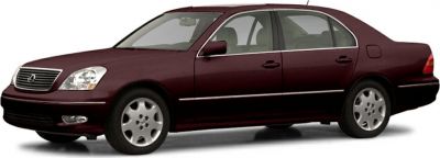 Side profile of a luxury sedan with a sleek design and classic alloy wheels