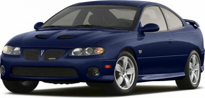 Front view of a sporty coupe with hood scoops and rear spoiler