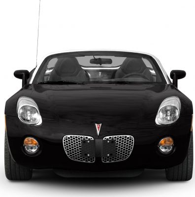 Front view of a sports convertible with honeycomb grille and dual headlights.