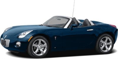 Side profile of a sleek convertible roadster with alloy wheels and sporty design.
