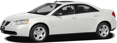 White sedan with alloy wheels and black side mirrors in side profile
