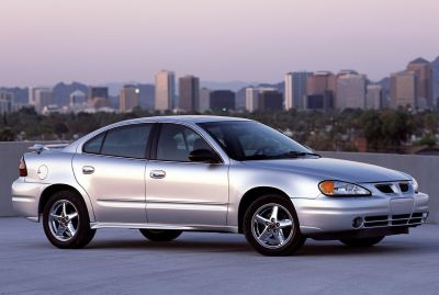 Silver sedan with 5-spoke alloy wheels and rear spoiler