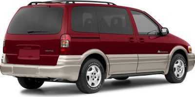 Rear side view of a dual-tone minivan with sliding door and tinted rear windows