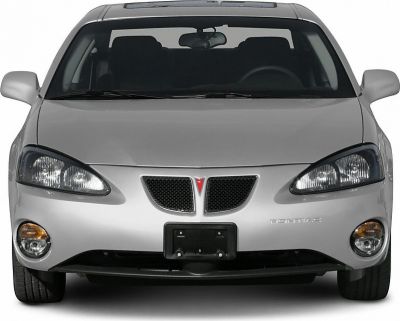 Front view, split grille, dual headlights, fog lights, silver sedan