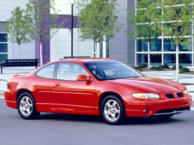 Red two-door sports coupe with aerodynamic design and alloy wheels
