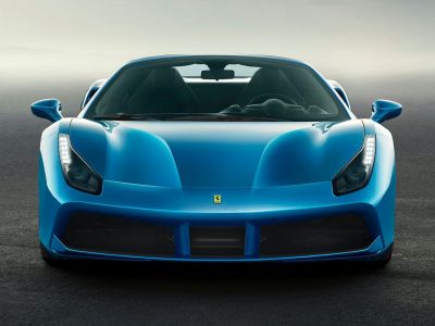 Aerodynamic hood and aggressive LED headlights of a luxury convertible.