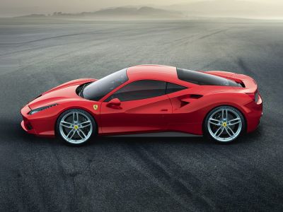 Side profile of a sports coupe with aerodynamic lines and alloy wheels.