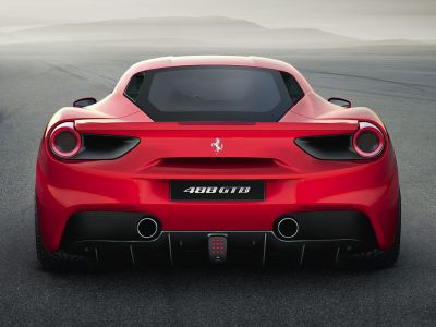 Dual exhaust pipes and round tail lights on a sleek rear design.