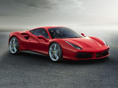 Sleek aerodynamic body with sharp headlights and alloy wheels in side-front view