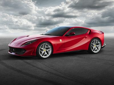 Side profile of sleek aerodynamic sports coupe with prominent alloy wheels