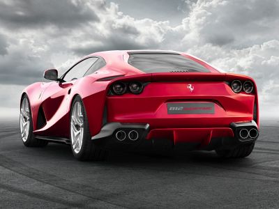 Rear view of a sports car with quad exhausts and circular tail lights