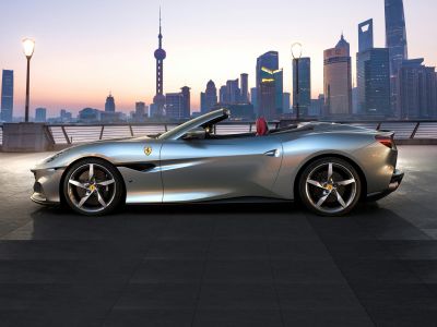 Convertible sports coupe side profile at sunset with alloy wheels
