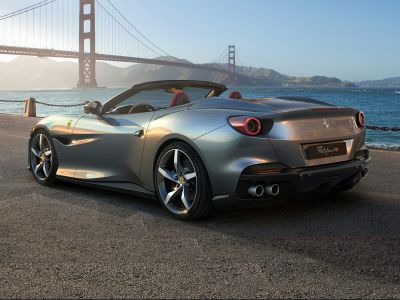 Rear view of convertible with round tail lights and dual exhausts