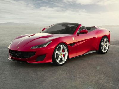 Red convertible sports coupe with aerodynamic hood vents and alloy wheels