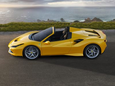 Yellow convertible sports coupe with aerodynamic design and alloy wheels