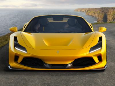 Yellow convertible sports car front with sleek headlights and aerodynamic design