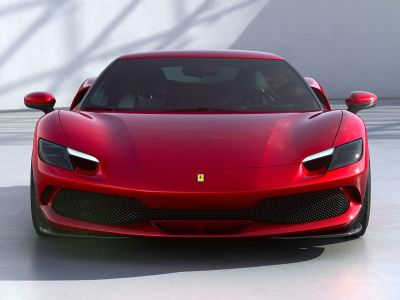 Front view showing sleek headlights and wide honeycomb grille
