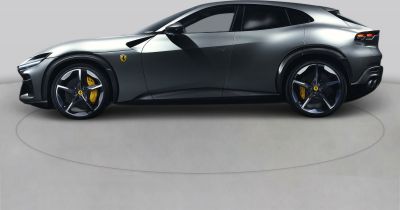 Side view of sleek sports SUV with large alloy wheels and aerodynamic lines
