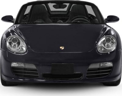 Close front view with distinctive headlights and smooth hood.
