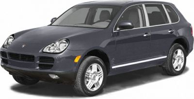 Dark-colored SUV with distinct headlamps and alloy wheels, viewed from front-side angle