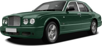 Front three-quarter view of green luxury sedan with round headlights and chrome grille.