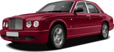 Front side view of a red luxury sedan with distinctive grille and round headlights.