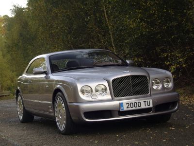 Luxury silver grand tourer with mesh grille and quad round headlights