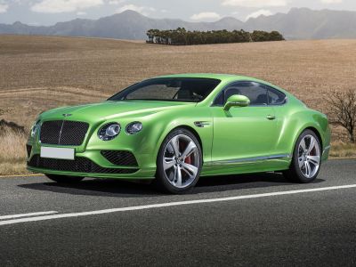Glossy green luxury coupe with large grille and dual round headlights