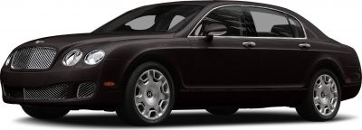 Front side view of luxury sedan with iconic grille and chrome-accented wheels