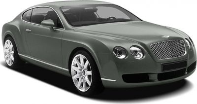 Front-angle view of a luxury coupe with dual round headlights and a large, mesh front grille.