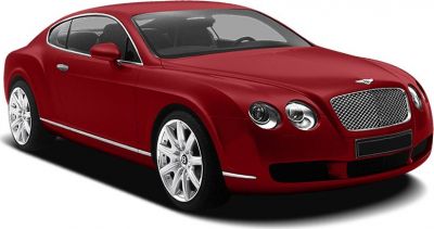 Red luxury coupe with dual round headlights and mesh grille.