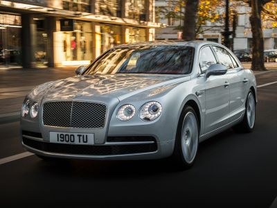 Front view luxury sedan with LED ring headlights and chrome grille