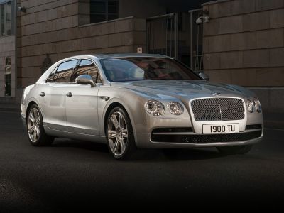 Silver luxury sedan with prominent front grille and dual round headlights