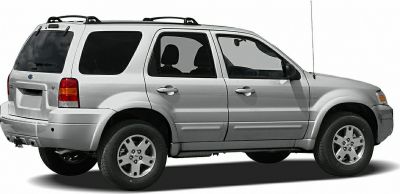 Side profile of silver early 2000s SUV with four doors and roof rails