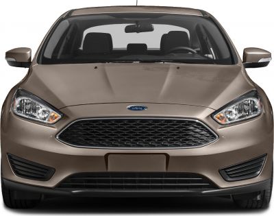 Front view with prominent grille and headlights