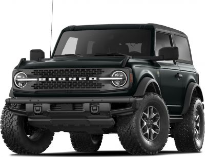 Front view shows round headlights, distinctive grille, and rugged off-road tires.