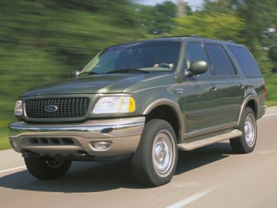 Front side profile of large SUV driving on road