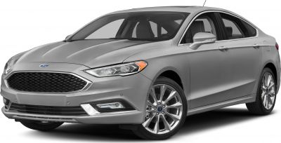 Front side view of a silver sedan with sleek grille and alloy wheels.