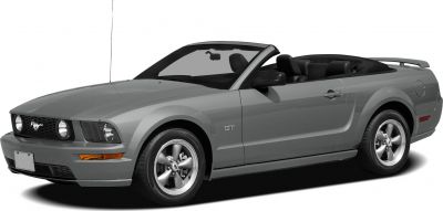 Front side view of a convertible Mustang with open roof and sporty wheels