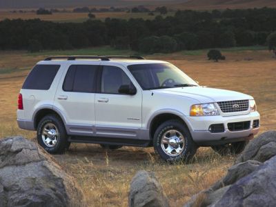 White SUV off-road in natural open landscape