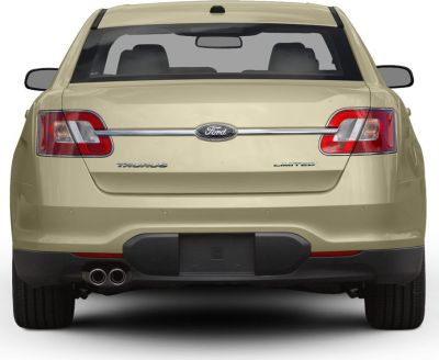 Rear view with dual exhaust and taillights.