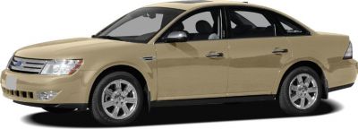Beige mid-size sedan side view with alloy wheels and aerodynamic design