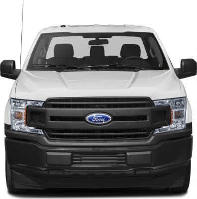 Front view close-up of pickup truck grille with headlights and bumper.