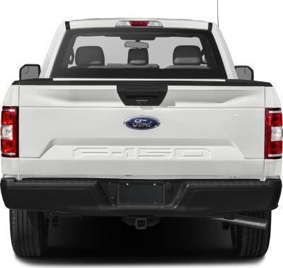 Rear view of a white pickup truck with embossed tailgate and rear window.