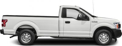 Side profile of a regular cab pickup truck with a long bed and steel wheels.