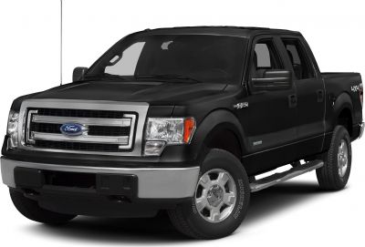 Front side view of black pickup with bold grille and off-road tires